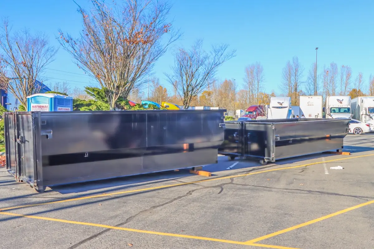 Professional dumpster rental service with roll-off container on residential driveway in Burleson